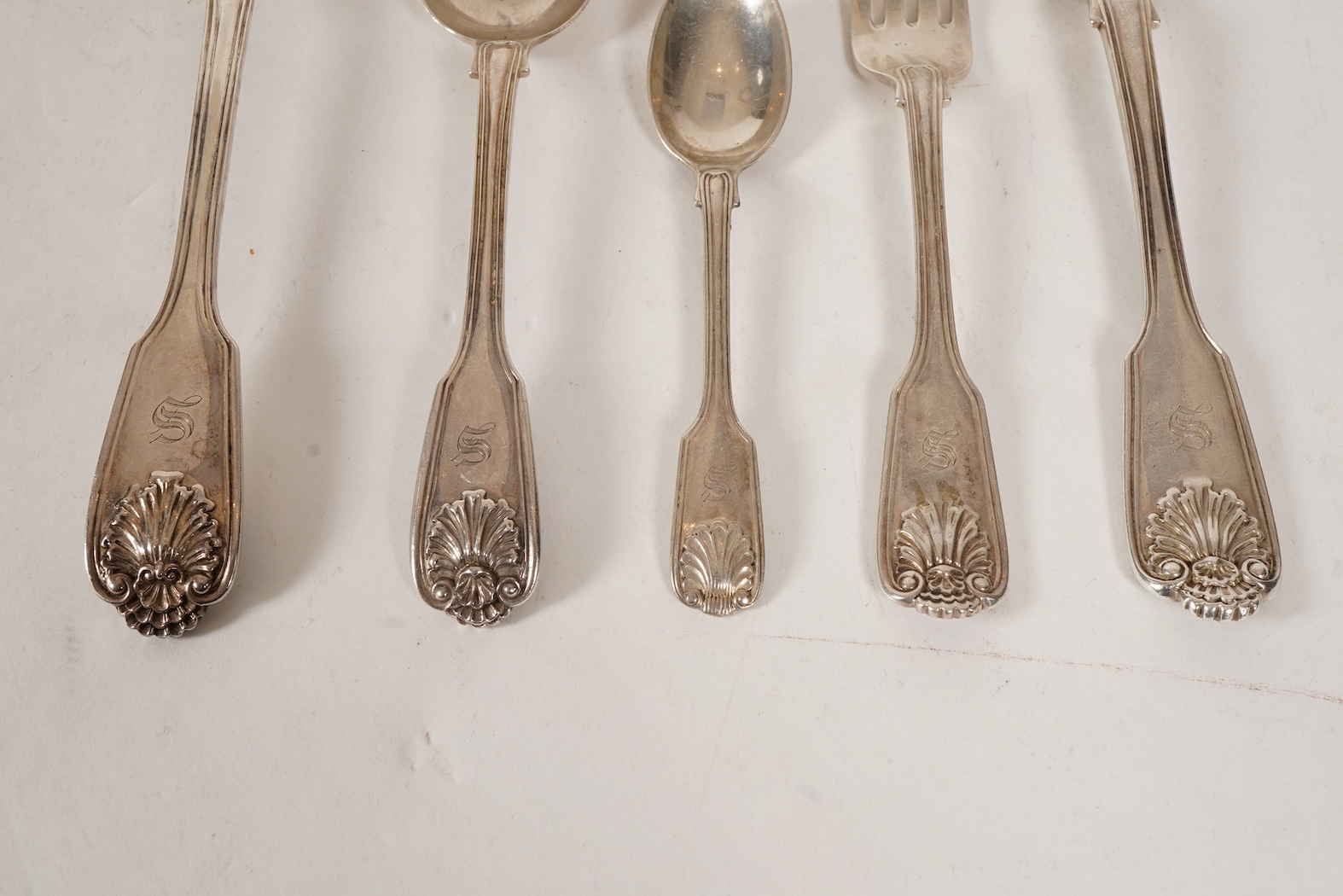 A matched part canteen of mainly 19th century silver double struck fiddle, thread and shell pattern flatware for twelve